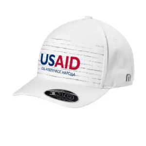 USAID Bosnian Cyrillic - Embroidered New TravisMathew FOMO Novelty Cap (Min 12 pcs)